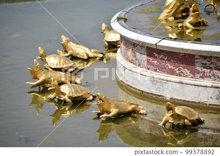 Statue of a golden turtle in the pond of the Palace of Versailles Statue of a golden turtle in the pond of the Palace of Versailles 99378892