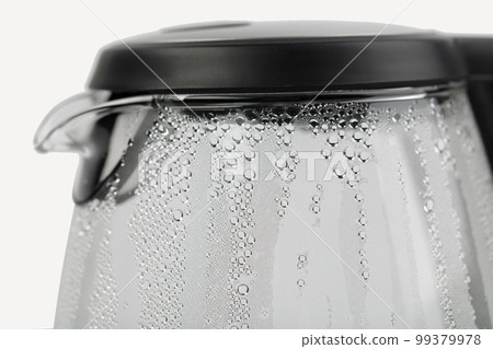 Electric glass teapot with water drops. 99379978