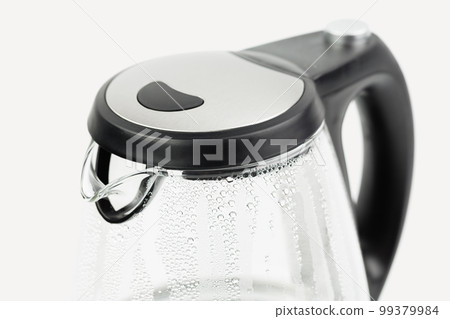 Electric glass teapot with water drops. Electric glass teapot with water drops. 99379984