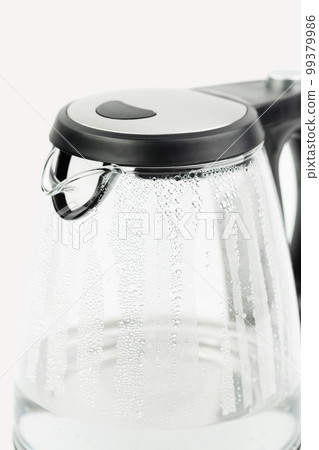 Electric glass teapot with water drops. 99379986