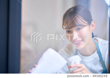 Housewife image of a housewife cleaning windows Housewife image of a housewife cleaning windows 99380248