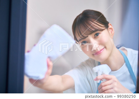 Housewife image of a housewife cleaning windows Housewife image of a housewife cleaning windows 99380250