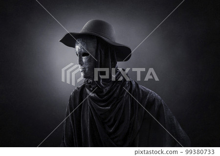 Creepy figure with old hat over dark misty background Creepy figure with old hat over dark misty background 99380733
