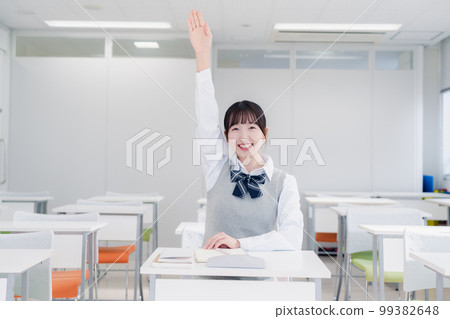 High school girl raising her hand in class High school girl raising her hand in class 99382648