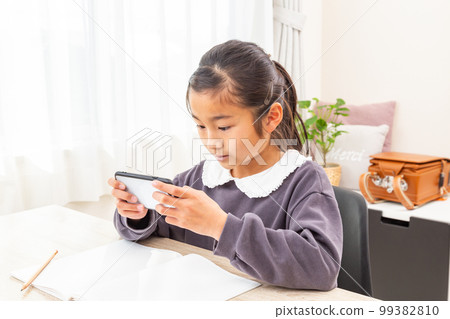 girl studying on smartphone girl studying on smartphone 99382810