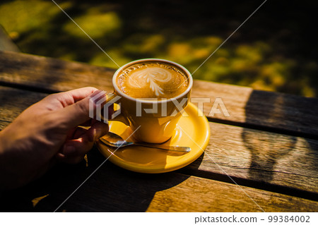 coffee cup on wooden desk 99384002