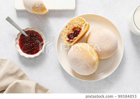 Berliner donut. Traditional german donut with raspberry jam, dusted with icing sugar. Top view Berliner donut. Traditional german donut with raspberry jam, dusted with icing sugar. Top view 99384853