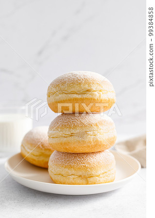 Berliner donut. Traditional german donut with raspberry jam, dusted with icing sugar 99384858