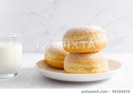 Berliner donut. Traditional german donut with raspberry jam, dusted with icing sugar Berliner donut. Traditional german donut with raspberry jam, dusted with icing sugar 99384859