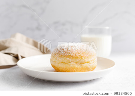 Berliner donut. Traditional german donut with raspberry jam, dusted with icing sugar Berliner donut. Traditional german donut with raspberry jam, dusted with icing sugar 99384860