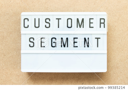 Lightbox with word customer segment on wood background 99385214