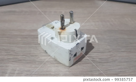 Burnout electrical appliances or electrical plug or electrical adapter dangerous 99385757