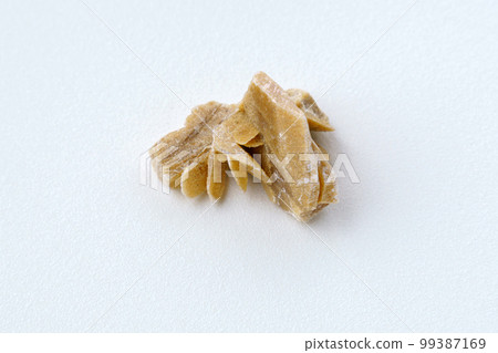 Desert Rose. Natural mineral close up of stone cluster from sand gypsum crystal, white background 99387169
