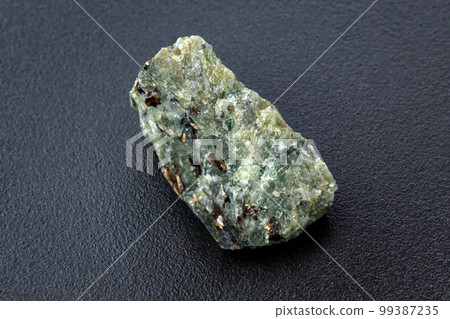 Natural chrysolite, olivine green color transparent raw crystal, close up Natural chrysolite, olivine green color transparent raw crystal, close up 99387235