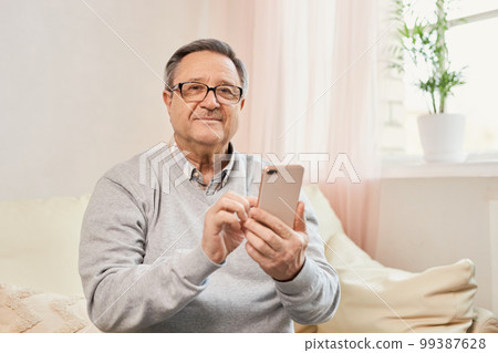 Portrait of smiling mature man using mobile phone 99387628