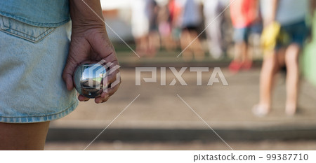 Senior playing petanque un and relaxing game. Senior woman prepared to throw the boules ball in a park in outdoor play Senior playing petanque un and relaxing game. Senior woman prepared to throw the boules ball in a park in outdoor play 99387710
