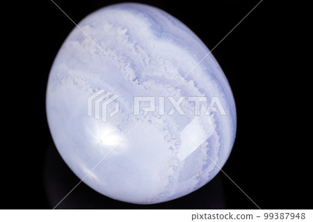 Macro mineral stone blue agate on black background 99387948