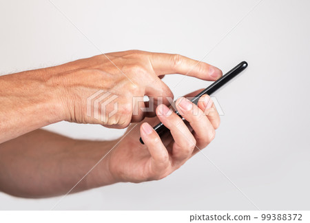 Man forefinger swiping phone screen. Male checking social media, running Internet, scooting through photos, web pages and news articles. 99388372