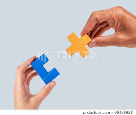 Man and woman hands joining two puzzle pieces. Partnership, connection concept. Mutual understanding, support in relations. Man and woman hands joining two puzzle pieces. Partnership, connection concept. Mutual understanding, support in relations. 99388428