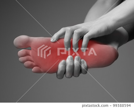 Foot pain. Hands holding leg with red point. Black and white. Inflammation, injury, chronic diseases consequences. Health problems concep 99388594