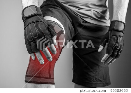 Knee pain, strain, injury. Kneecap aching from sport gym trauma in elastic supporting bandage, sleeve, brace 99388663