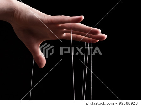 Woman hand with strings on fingers. Victim of domestic violence, slavery. Negative abusive relationship, manipulation, control, power concept. 99388928