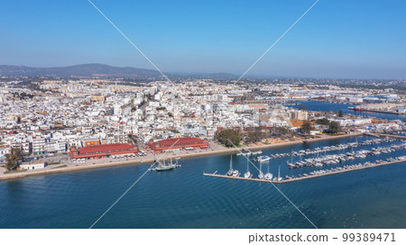 Aerial view of the Portuguese fishing tourist town of Olhao overlooking the Ria Formosa Marine Park. sea port for yachts and Municipal market Aerial view of the Portuguese fishing tourist town of Olhao overlooking the Ria Formosa Marine Park. sea port for yachts and Municipal market 99389471