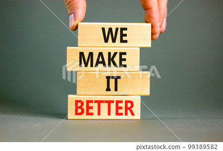 We make it better symbol. Concept words We make it better on wooden blocks. Beautiful grey table grey background. Businessman hand. Business we make it better concept. Copy space. 99389582