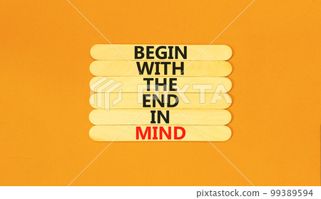 Begin in end of mind symbol. Concept words Begin with the end in mind on wooden stick. Beautiful orange table orange background. Business begin in end of mind concept. Copy space. 99389594