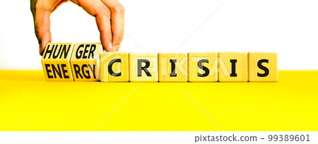 Energy or hunger crisis symbol. Concept word Energy crisis and hunger crisis on wooden cubes. Beautiful white background. Businessman hand. Business Energy or hunger crisis concept. Copy space. 99389601