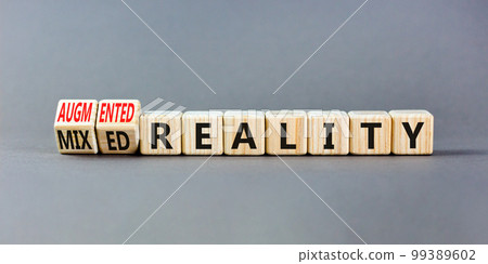 Augmented or mixed reality symbol. Concept words Augmented reality Mixed reality on wooden cubes. Beautiful grey table grey background. Business augmented or mixed reality concept. Copy space. 99389602