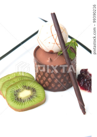 chocolate mousse presented with a scoop of ice cream and natural kiwi 99390216