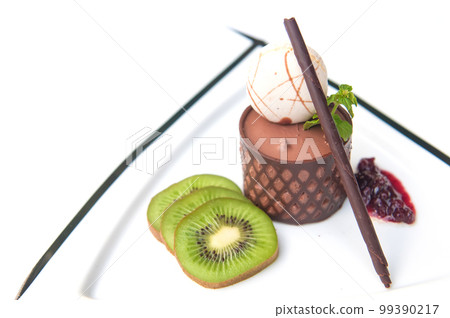 chocolate mousse presented with a scoop of ice cream and natural kiwi 99390217