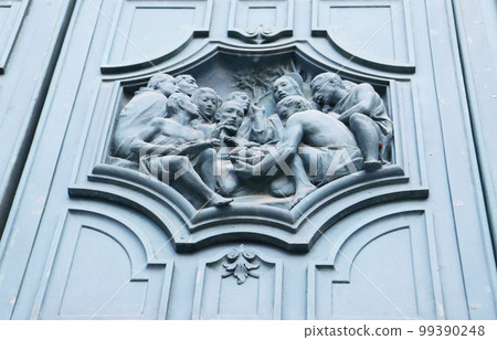 Close up fragment of medieval metal doors with decorative elements. Part of antique old door Close up fragment of medieval metal doors with decorative elements. Part of antique old door 99390248