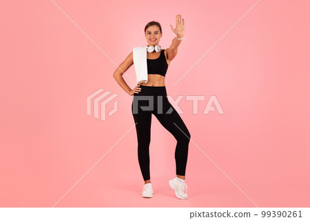 Sporty Young Woman In Activewear Giving High Five At Camera 99390261