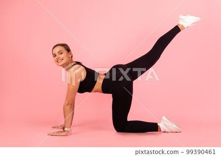 Body Shaping Concept. Smiling Sporty Woman Doing Leg Raise Exercise 99390461