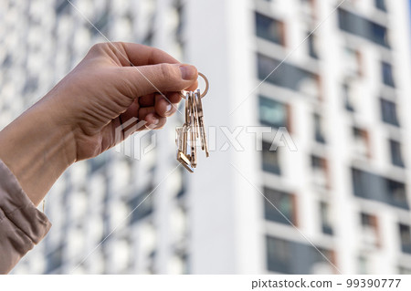 male hand holding house key,real estate agent. male hand holding house key,real estate agent. 99390777