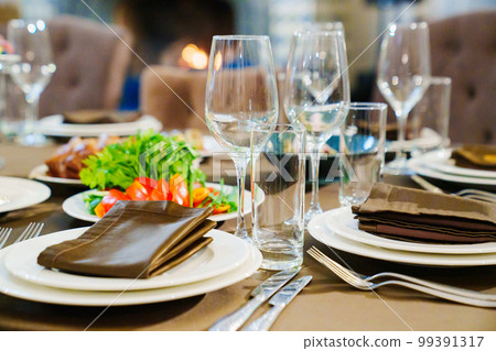 a festive served table with snacks and tableware. 99391317