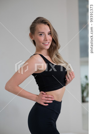 Portrait of a beautiful caucasian woman in black sportswear. Portrait of a beautiful caucasian woman in black sportswear. 99391373