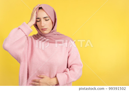 Muslim woman with scarf not feeling well Muslim woman with scarf not feeling well 99391502