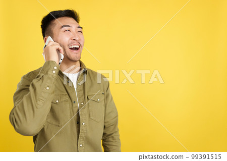 Happy chinese man talking to the mobile Happy chinese man talking to the mobile 99391515