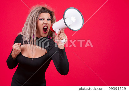 Angry transgender person shouting using a loudspeaker Angry transgender person shouting using a loudspeaker 99391529