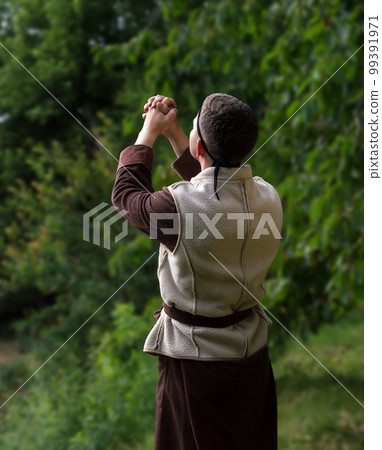 Praying man with raised hands Praying man with raised hands 99391971