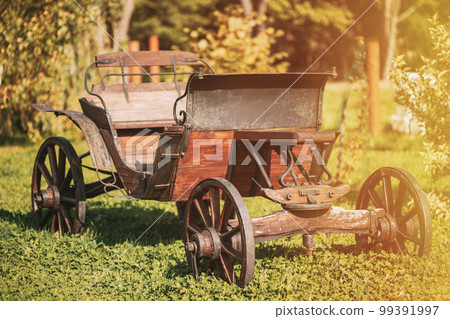 Garden Decoration Concept. Decorative Yard Wagon On Summer Lawn. Bright Sunny Day. Gardening And Housekeeping. Vintage Cart On Summer Sunny Day. Garden Wagon. Trolley. Old Wooden Cart 99391997