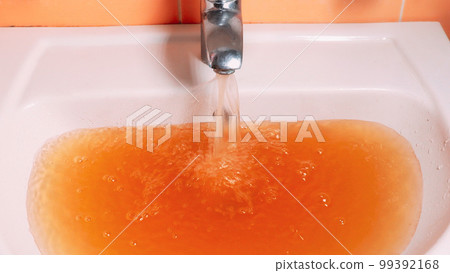 Rusty Water Pours From Tap. Water Pollution. Global Environment Rusty Water Pours From Tap. Water Pollution. Global Environment 99392168