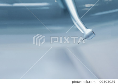 closeup of dental stainless steel drill bit on blue blurry background with copyspace 99393085