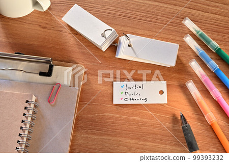 A desk with a deck that says "Initial Public Offering" 99393232