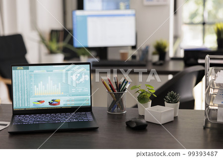 Investment advisory company displaying world stock market data on portable computer screen. Laptop with statistical graphs with unmanned workstations, coworking workplace. Investment advisory company displaying world stock market data on portable computer screen. Laptop with statistical graphs with unmanned workstations, coworking workplace. 99393487