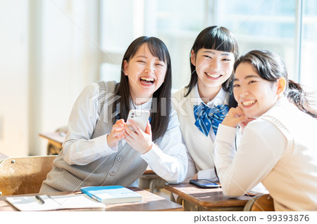 High school girl smartphone classroom 99393876