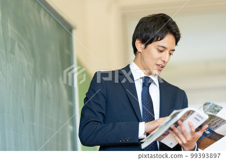 Male teacher teaching in a classroom Male teacher teaching in a classroom 99393897